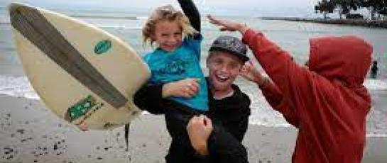 Kids with surfboard playing on the beach