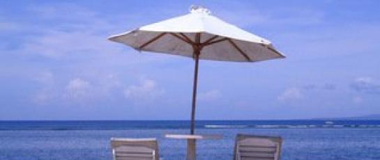 Umbrella and lounge chairs overlooking the ocean on the beach