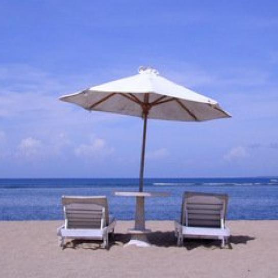Umbrella and lounge chairs overlooking the ocean on the beach