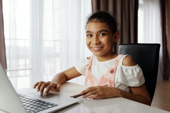 Smiling girl working on a computer
