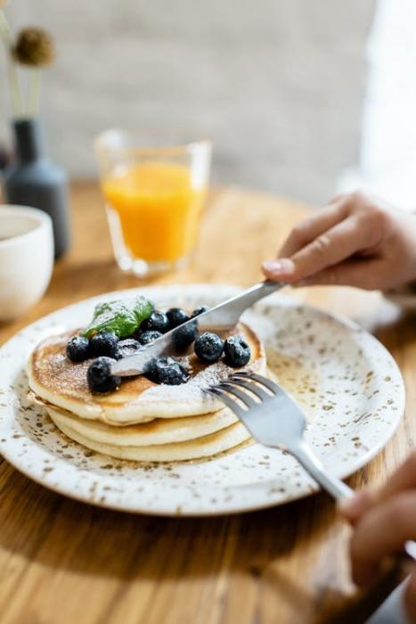 Pancakes with blueberries and orange juice. There are many local restaurants to from which to choose.
